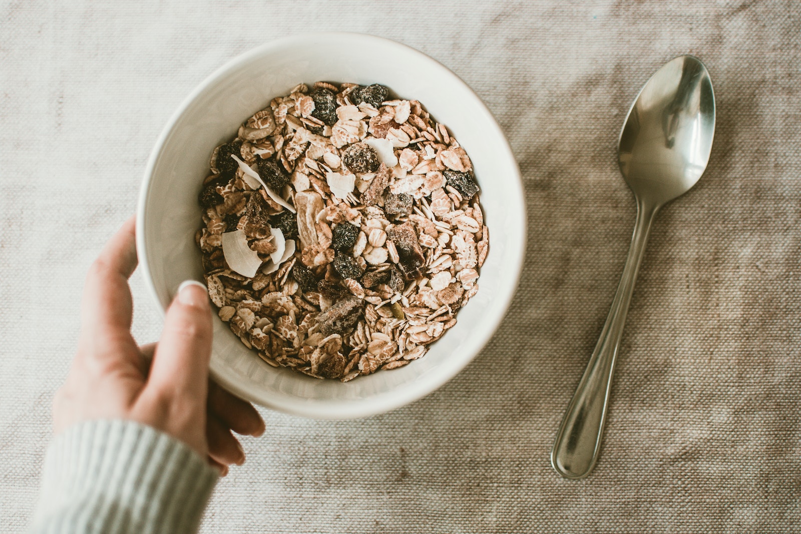Person Holding Bowl Full of Oats