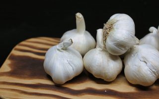 Garlic Bulbs on Brown Surface