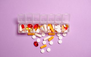 Photo Medication Pills on White Plastic Container