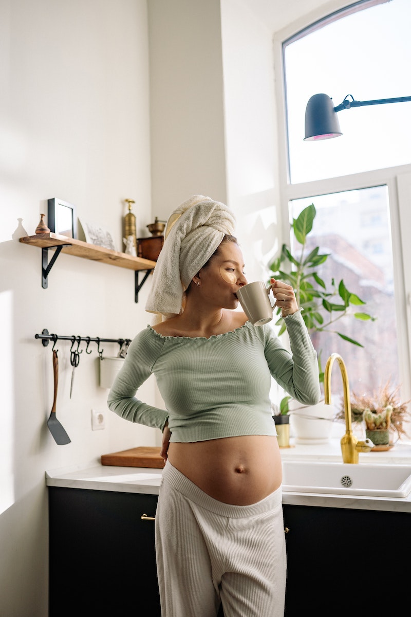 A Pregnant Woman Having a Cup of Hot Drink